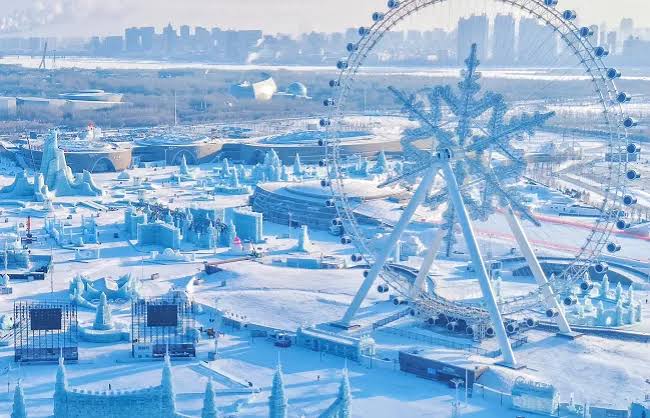 Snow Town's rooftops lit up at night